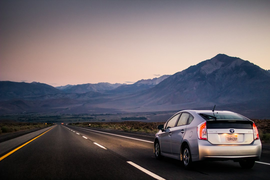 Car driving along an open road, representing car insurance quotes from an Ontario insurance broker